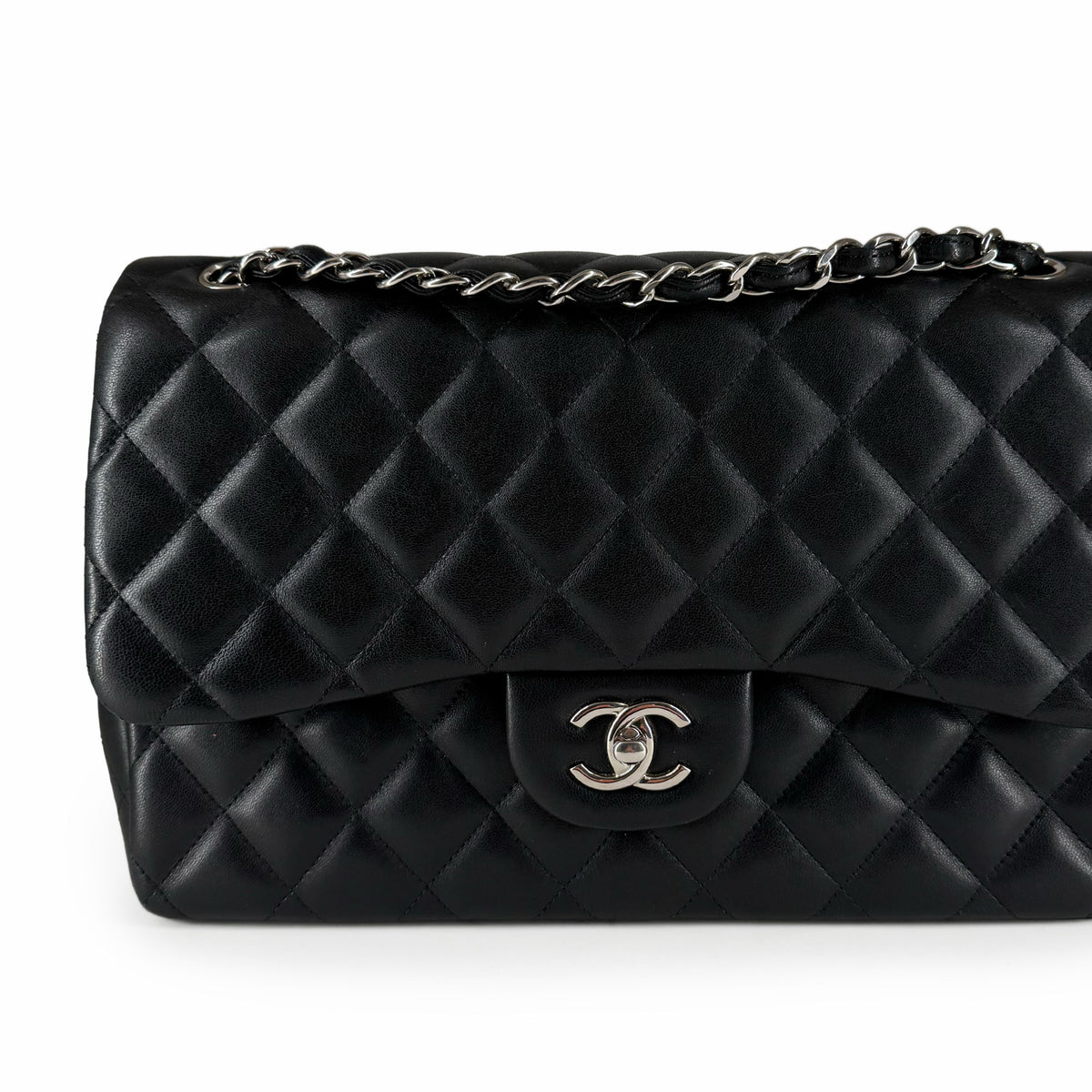 Black quilted lambskin leather flap handbag with silver-tone chain and CC clasp, curated Pre-loved Luxury by Myluxe in Helsinki.
