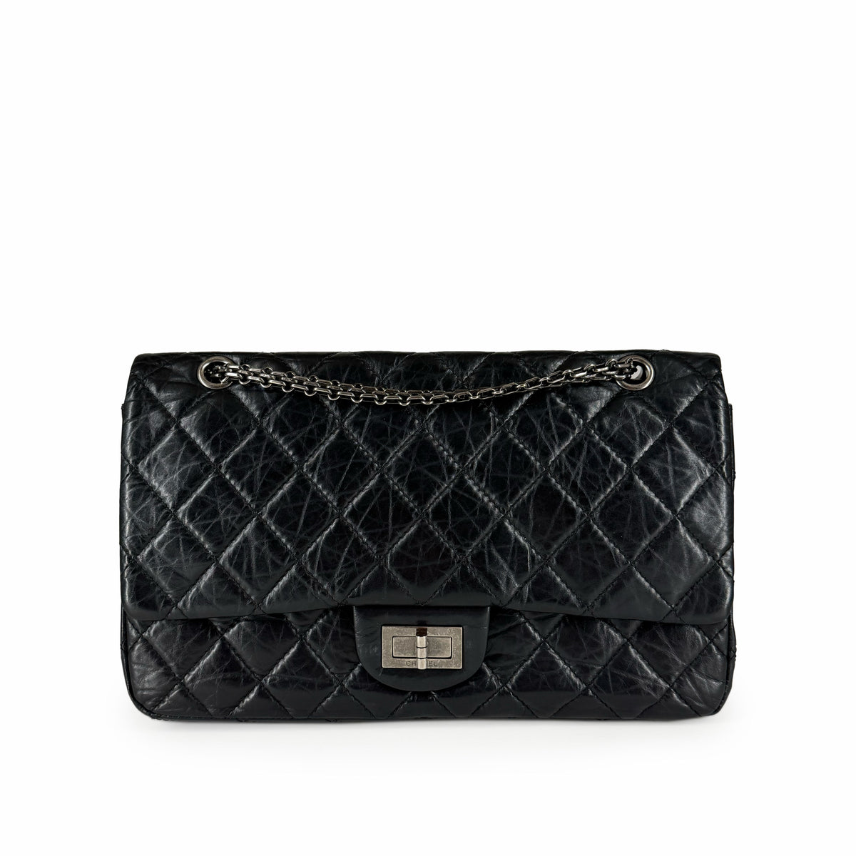 Black quilted leather flap clutch with silver chain strap, curated Pre-loved Luxury by Myluxe in Helsinki.