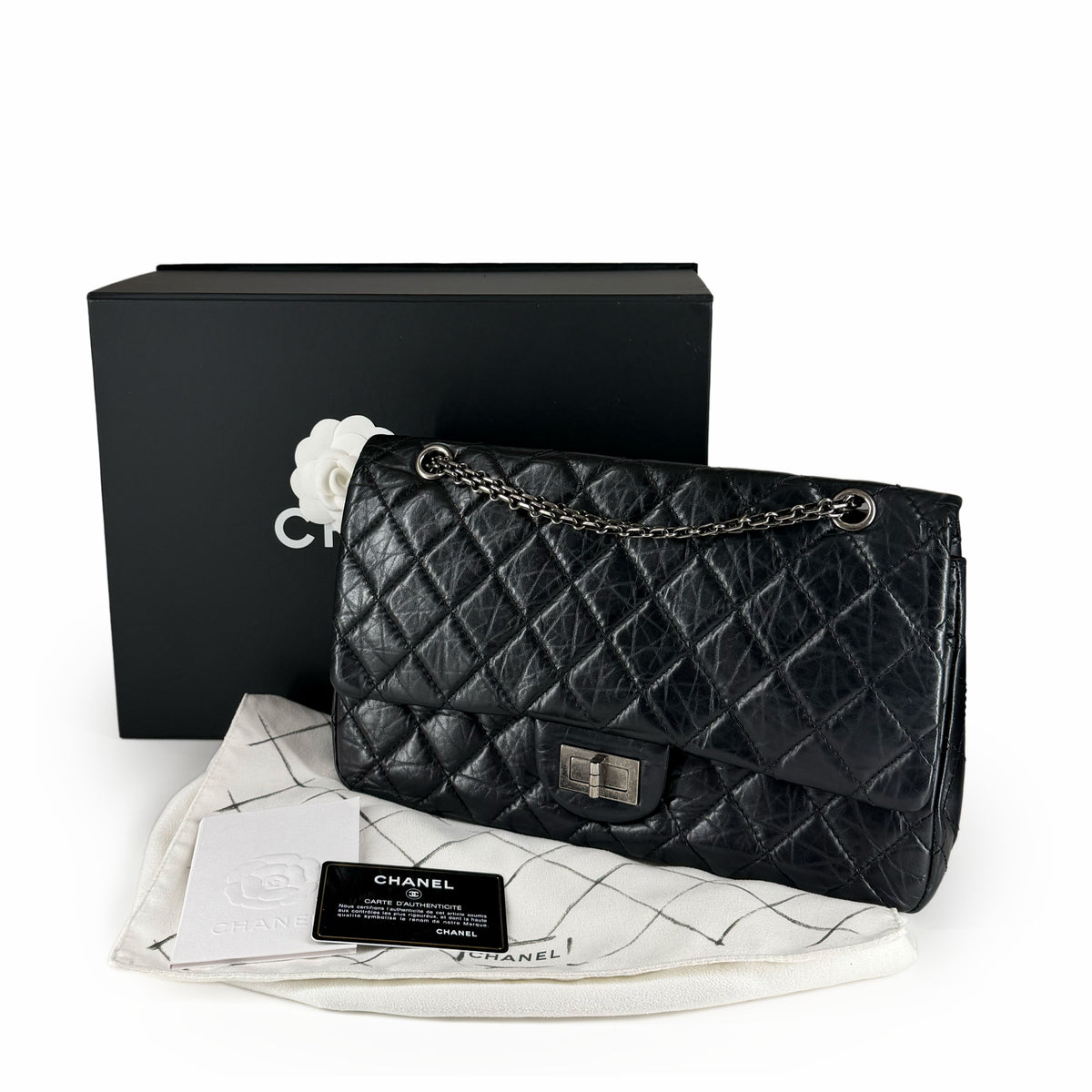 Black quilted lambskin Chanel flap bag with silver-tone chain strap, curated Pre-loved Luxury by Myluxe in Helsinki.