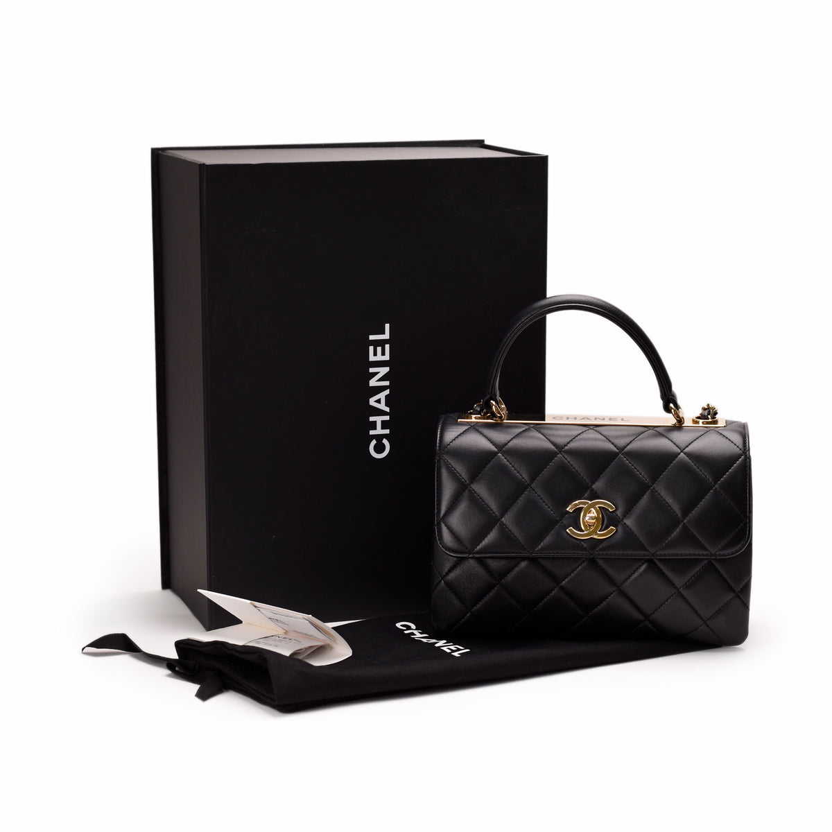 Black quilted leather Chanel handbag with gold CC logo and original box. curated Pre-loved Luxury by Myluxe in Helsinki.