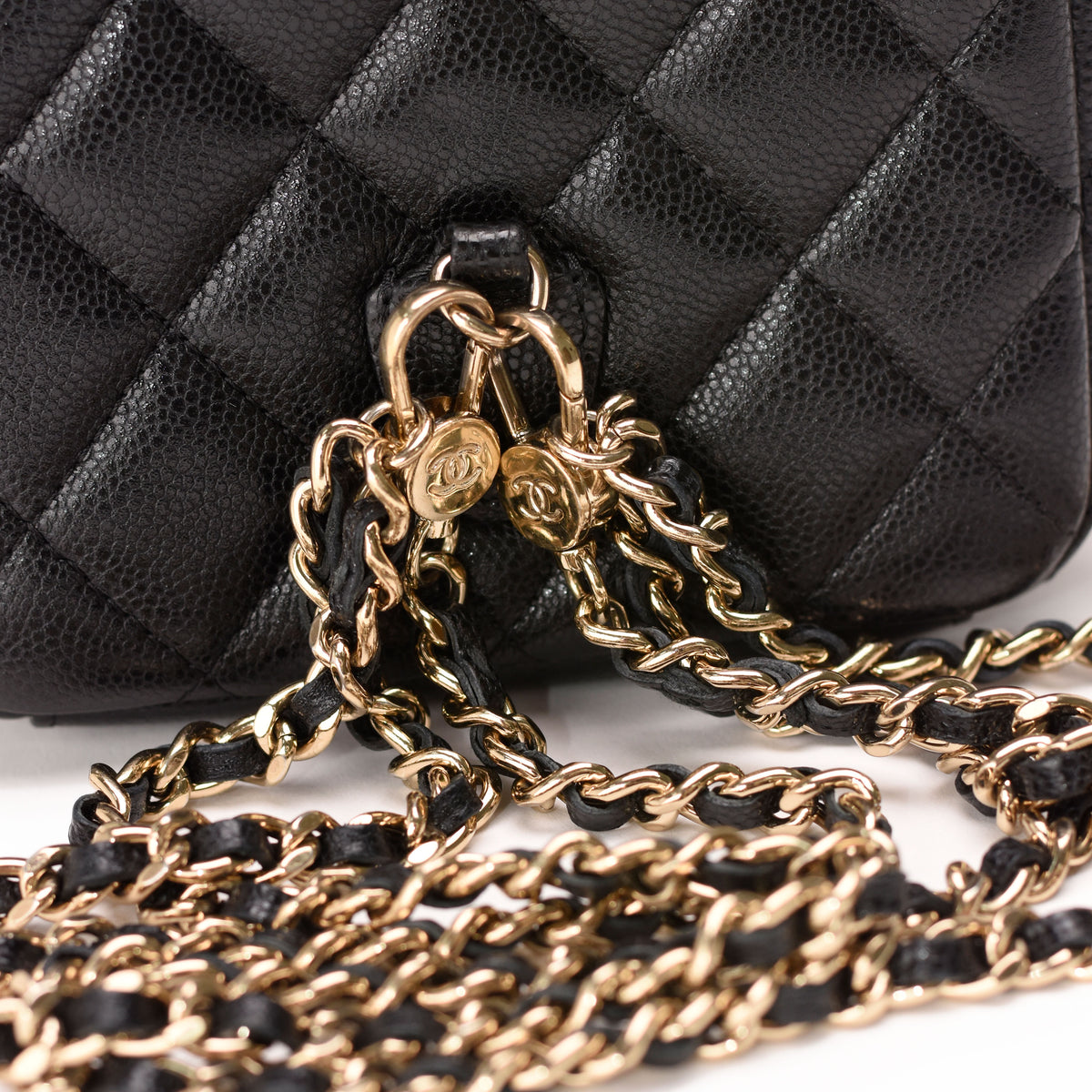 Black quilted caviar leather Chanel handbag with gold-tone chain strap, curated Pre-loved Luxury by Myluxe in Helsinki.
