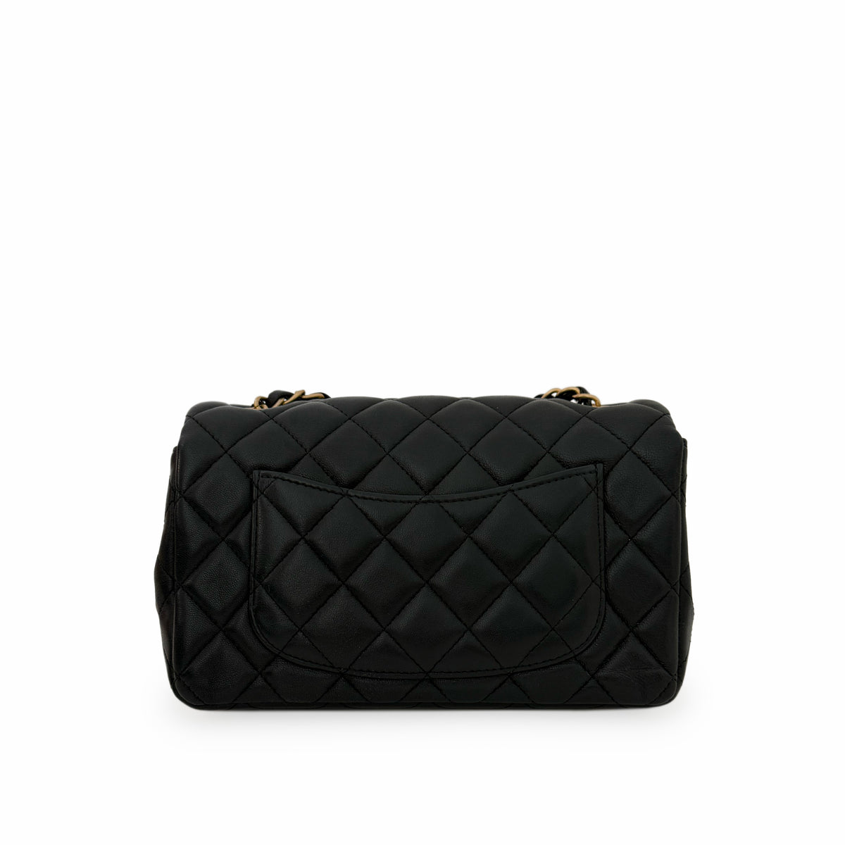 Black quilted lambskin leather flap handbag with gold chain strap, curated Pre-loved Luxury by Myluxe in Helsinki.