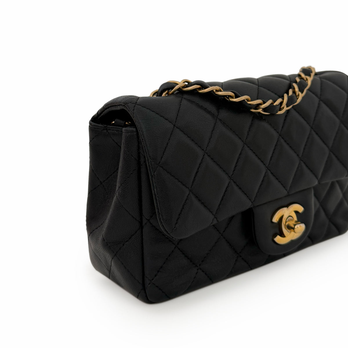 Black quilted lambskin Chanel flap bag with gold-tone hardware, curated Pre-loved Luxury by Myluxe in Helsinki.