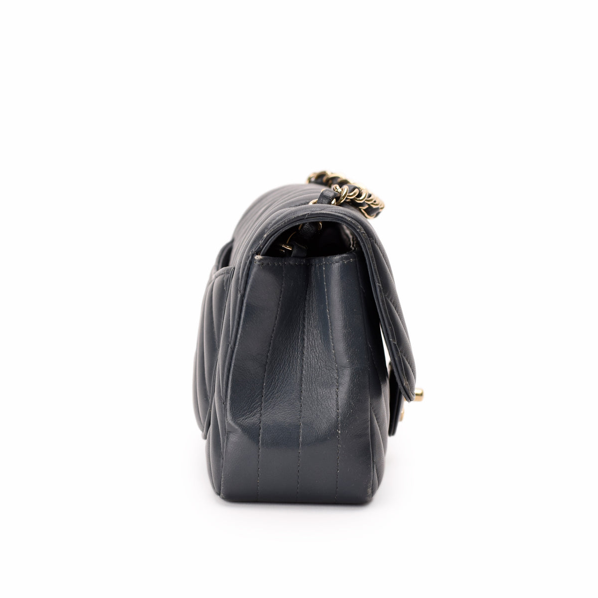 Black quilted leather designer handbag with gold chain strap, curated Pre-loved Luxury by Myluxe in Helsinki.