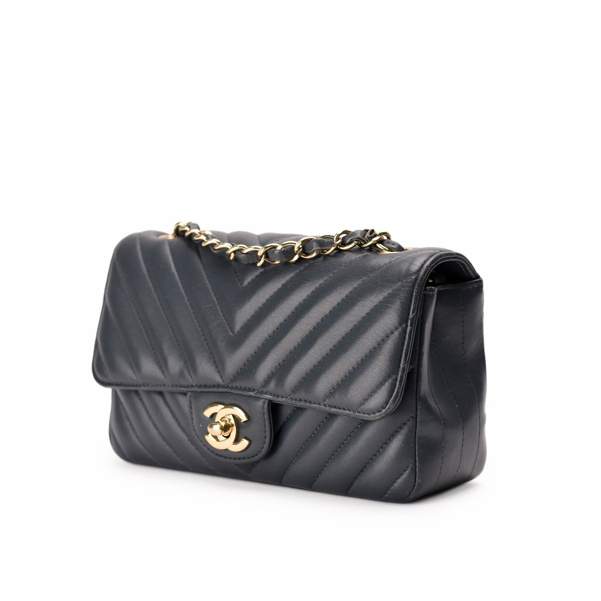Black chevron quilted leather Chanel handbag with gold chain strap, curated Pre-loved Luxury by Myluxe in Helsinki.
