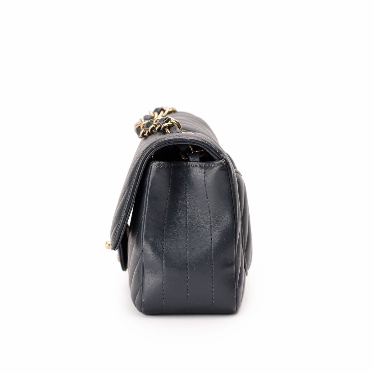 Black quilted leather handbag with gold chain strap, curated Pre-loved Luxury by Myluxe in Helsinki.