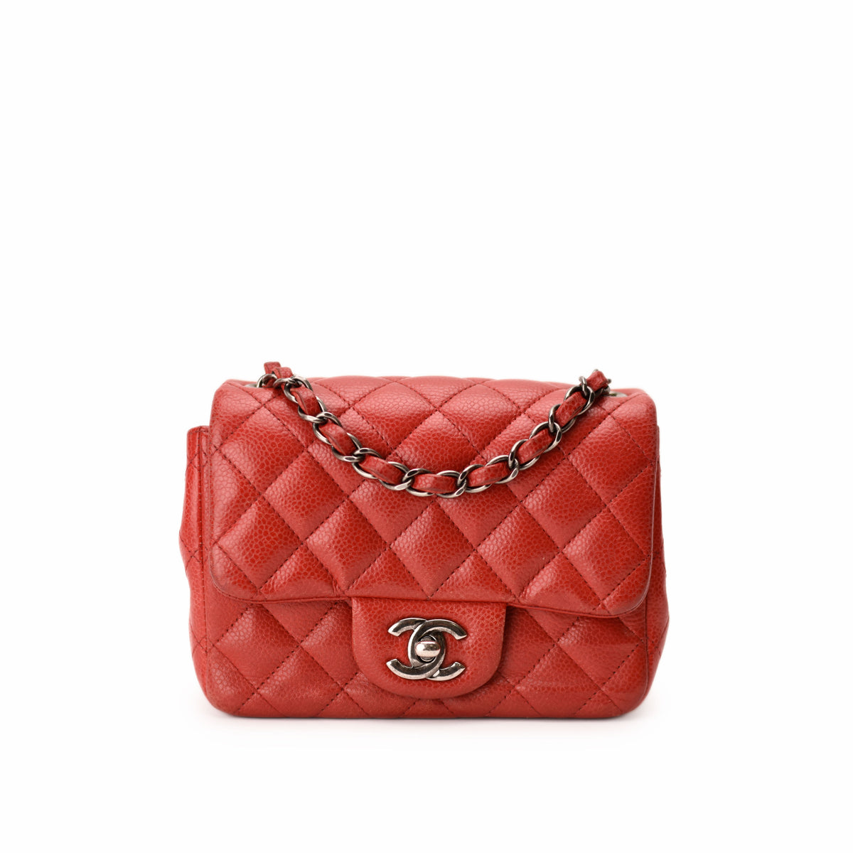 Red quilted leather Chanel flap bag with silver chain strap. curated Pre-loved Luxury by Myluxe in Helsinki.