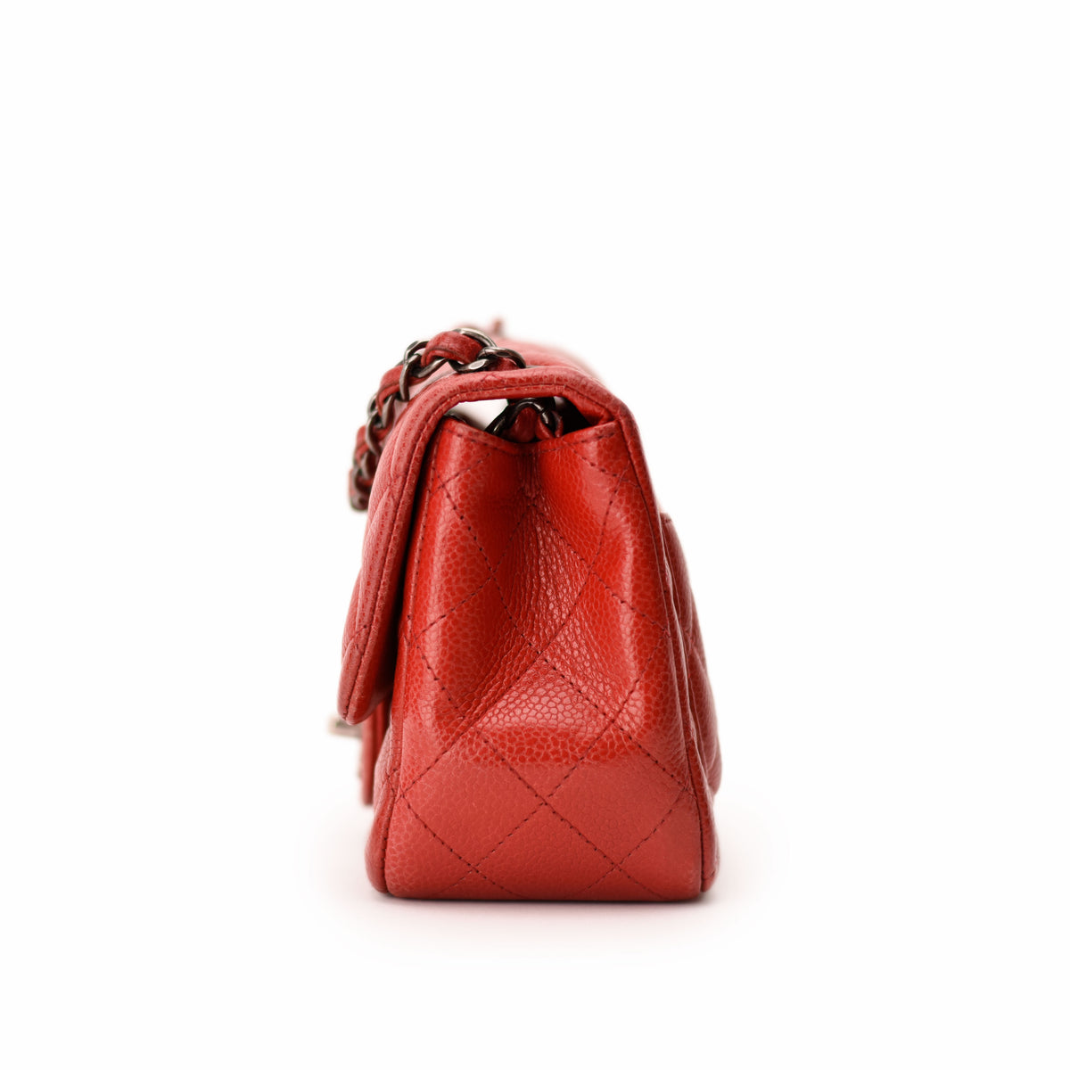 Red quilted lambskin Chanel flap bag with silver chain strap. curated Pre-loved Luxury by Myluxe in Helsinki.