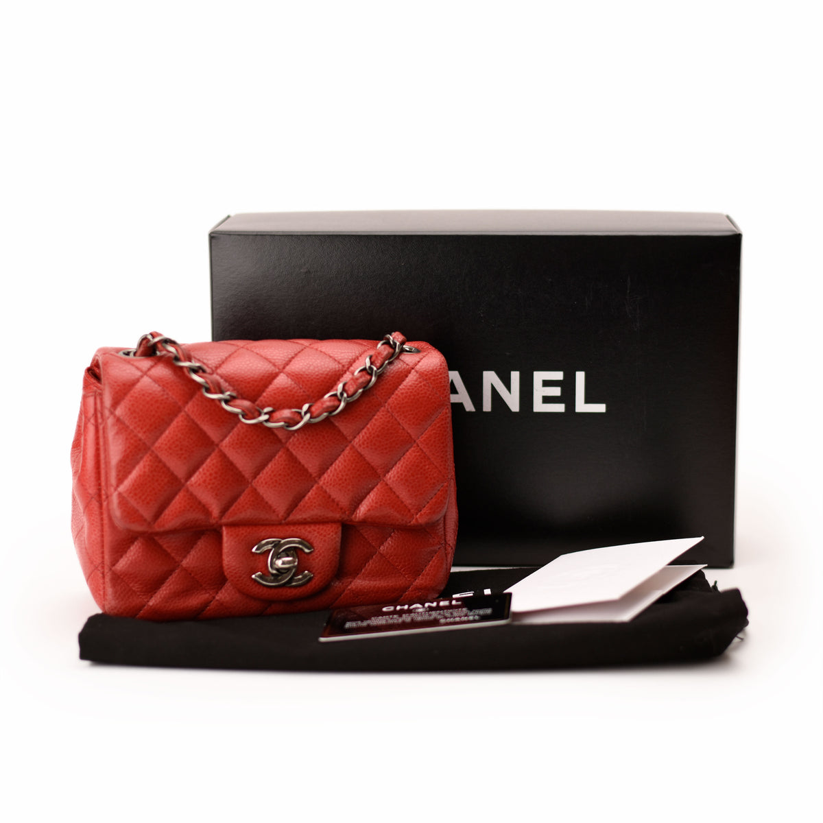 Red quilted Chanel handbag with silver chain strap and logo, curated Pre-loved Luxury by Myluxe in Helsinki.