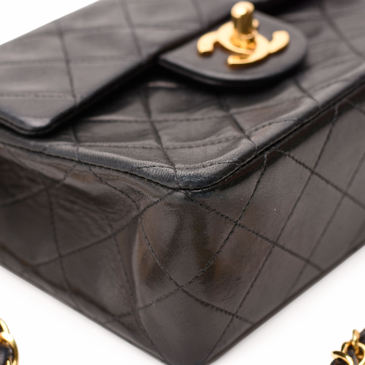 Black quilted lambskin Chanel flap bag with gold-tone hardware, curated Pre-loved Luxury by Myluxe in Helsinki.