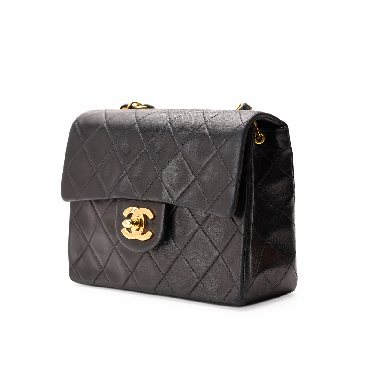 Black quilted lambskin Chanel flap bag with gold-tone hardware, curated Pre-loved Luxury by Myluxe in Helsinki.