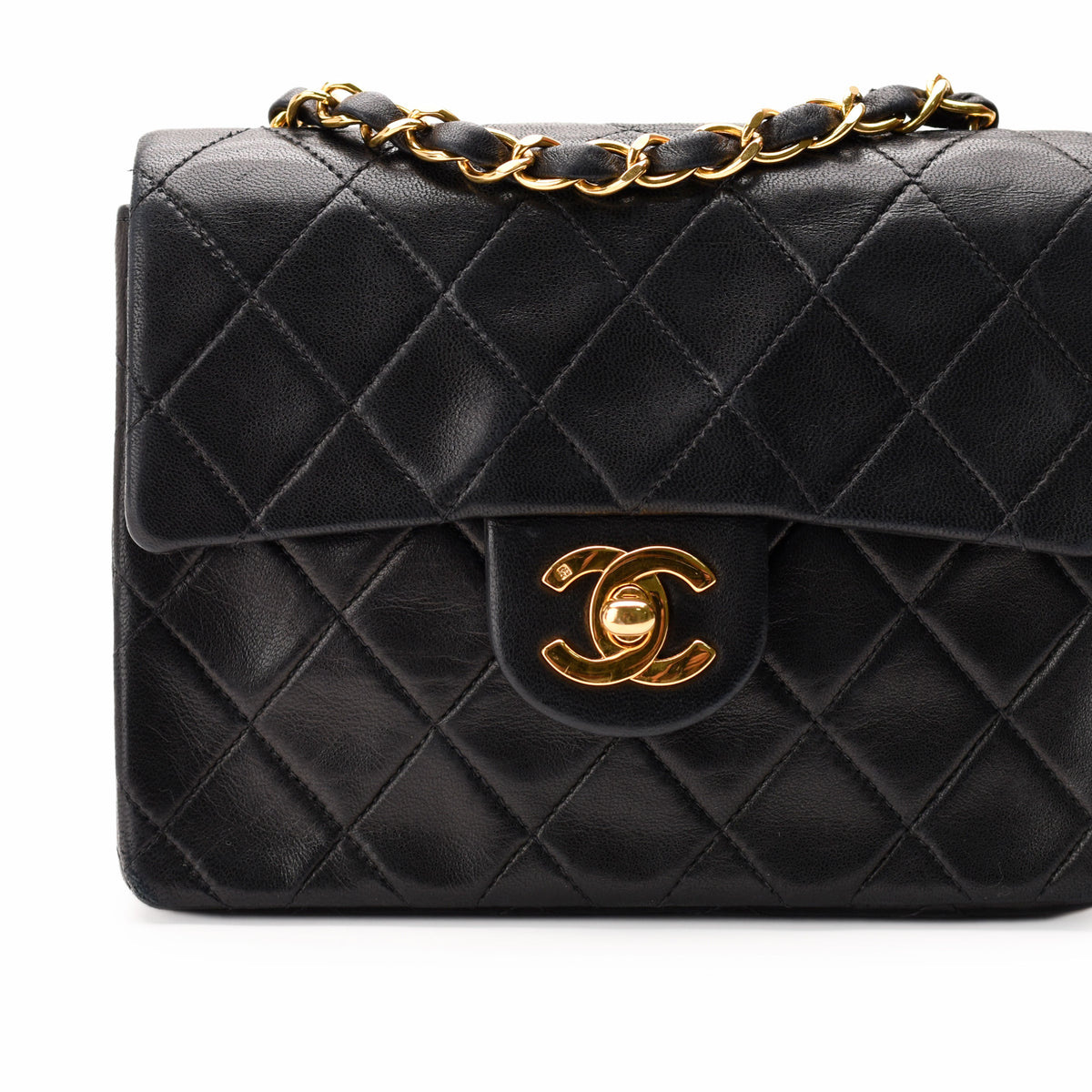 Black quilted leather Chanel flap bag with gold-tone chain and CC hardware, curated Pre-loved Luxury by Myluxe in Helsinki.