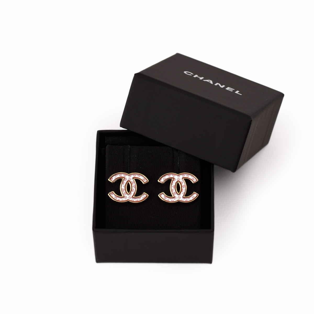 Chanel gold-tone interlocking CC earrings with pink crystals in black box. curated Pre-loved Luxury by Myluxe in Helsinki.