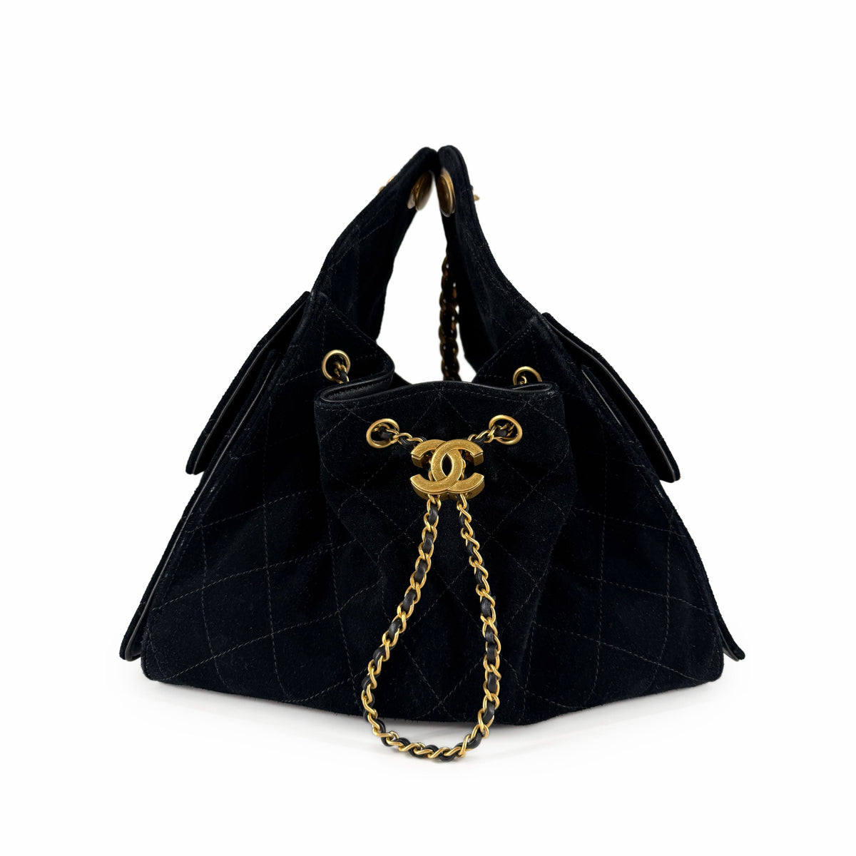 Black quilted suede Chanel bucket bag with gold-tone chain strap, curated Pre-loved Luxury by Myluxe in Helsinki.