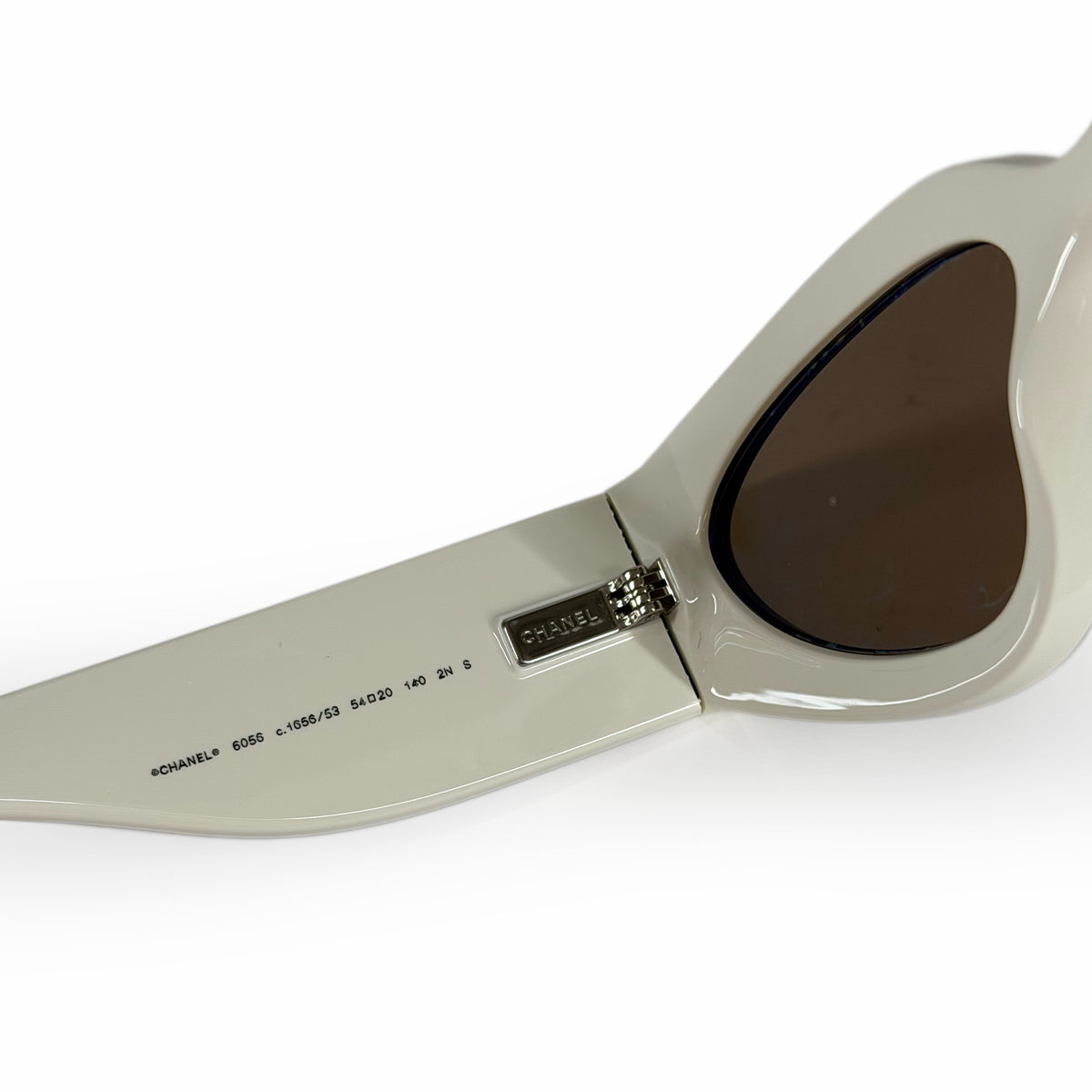 Chanel cream-colored cat-eye sunglasses with dark lenses, curated Pre-loved Luxury by Myluxe in Helsinki.