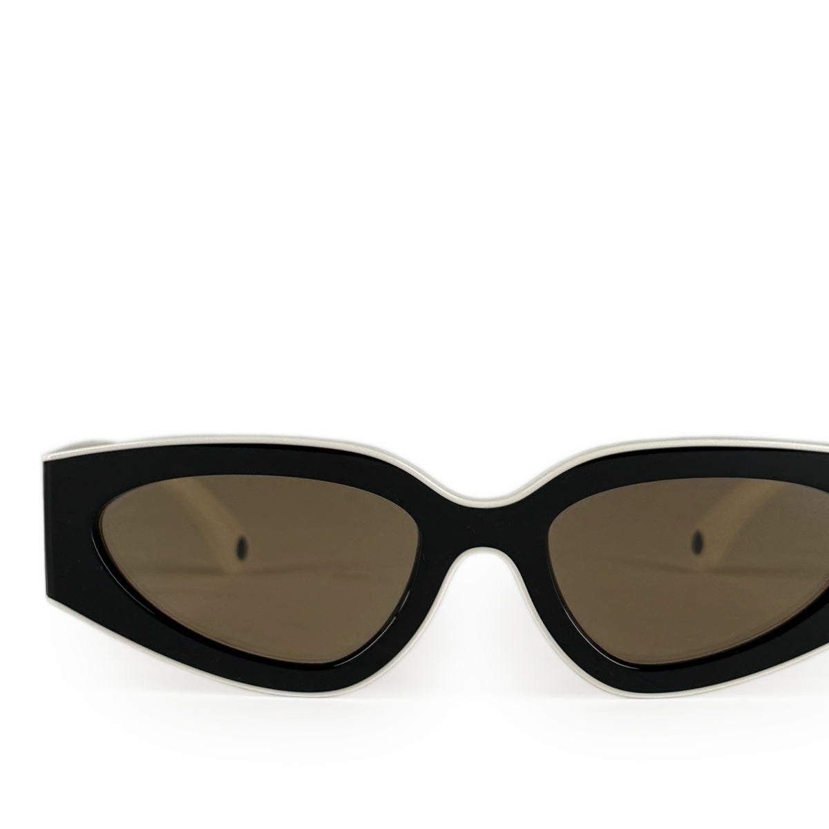 Black and white cat-eye sunglasses with dark brown tinted lenses, curated Pre-loved Luxury by Myluxe in Helsinki.