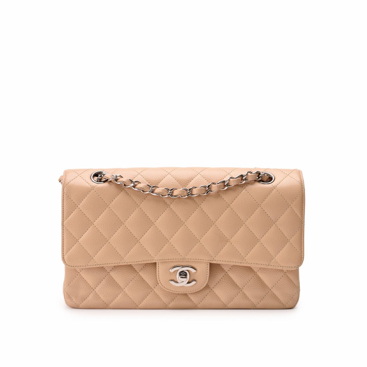 Beige quilted leather Chanel flap bag with silver chain strap, curated Pre-loved Luxury by Myluxe in Helsinki.