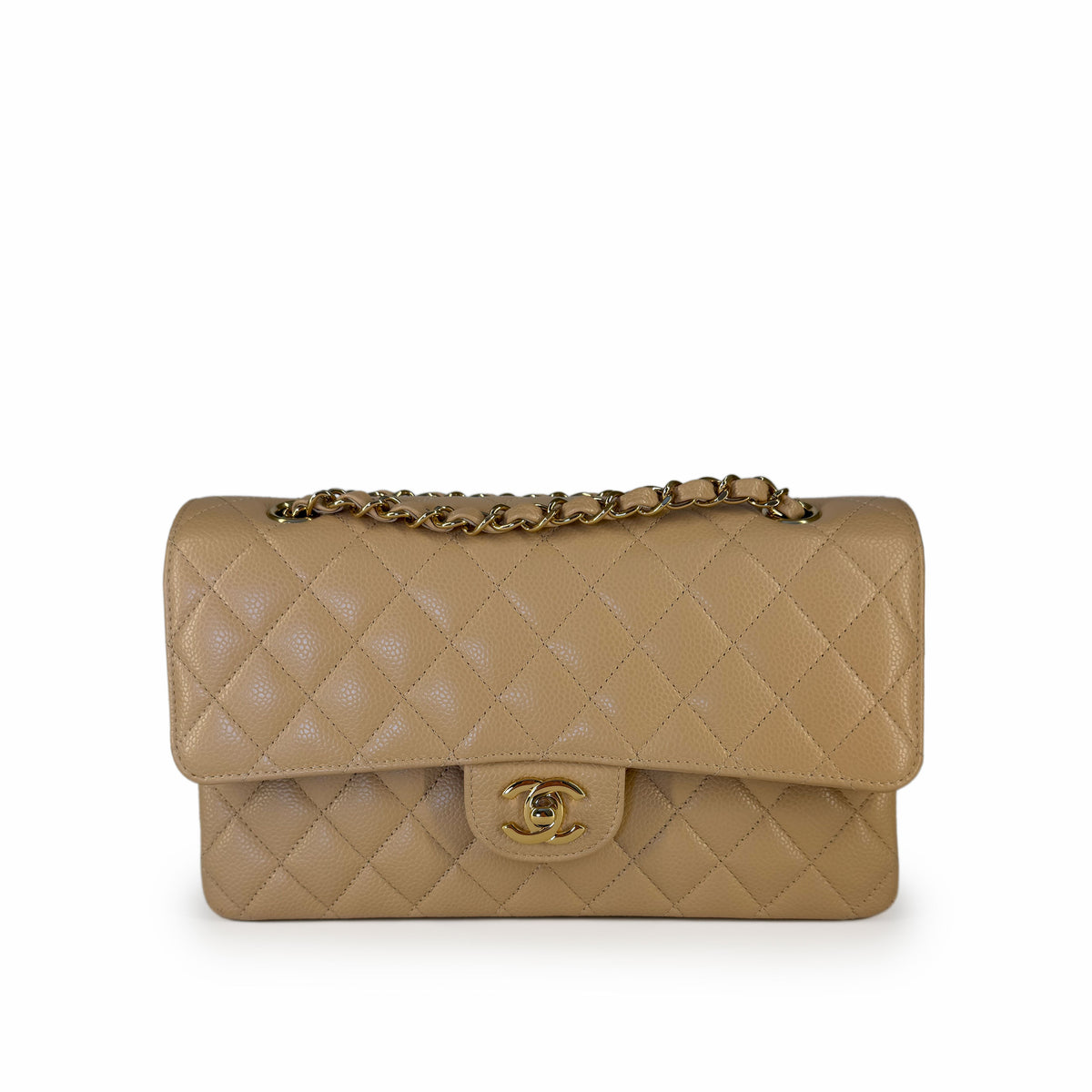 Beige quilted leather Chanel flap bag with gold chain strap, curated Pre-loved Luxury by Myluxe in Helsinki.