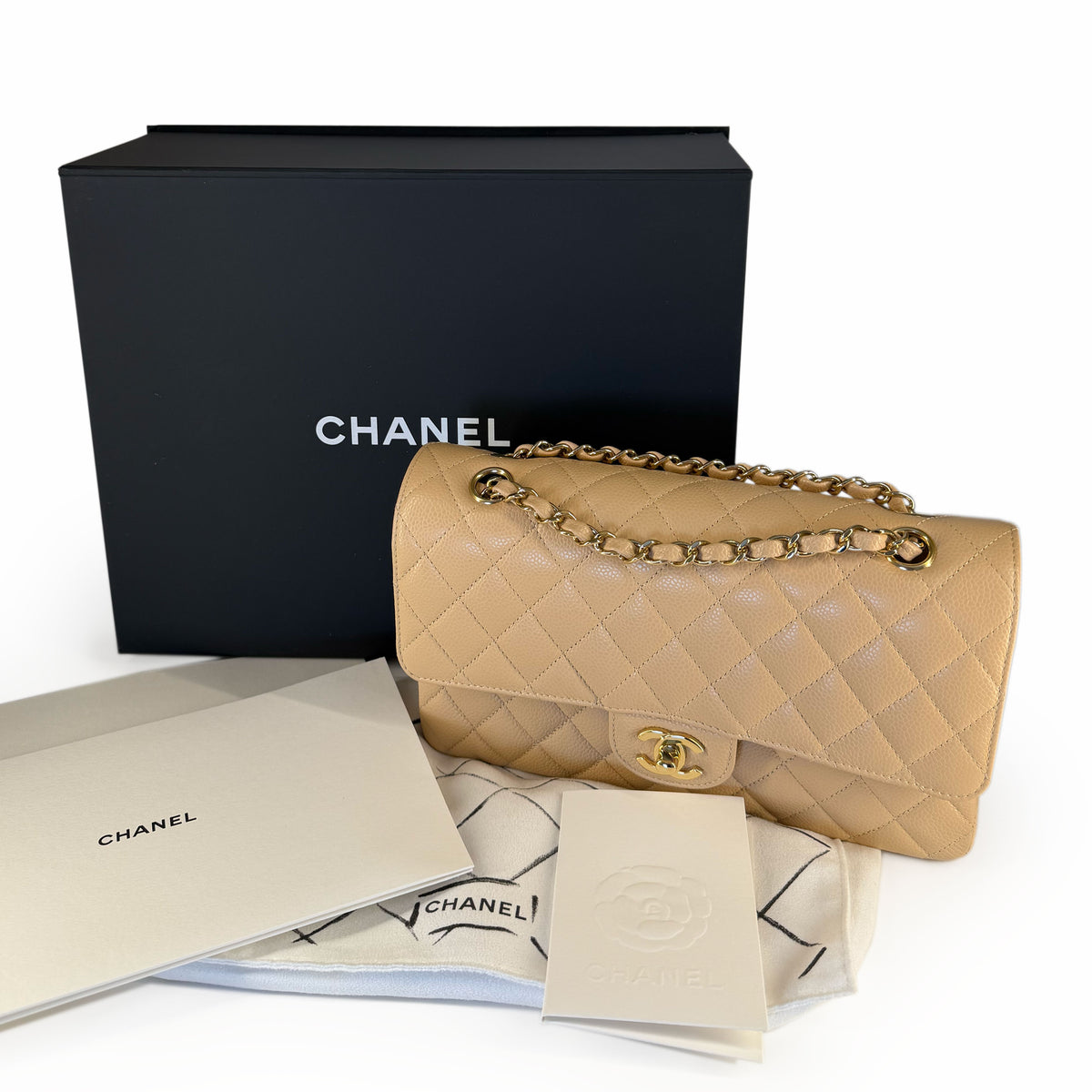 Beige quilted leather Chanel flap bag with gold chain strap, curated Pre-loved Luxury by Myluxe in Helsinki.