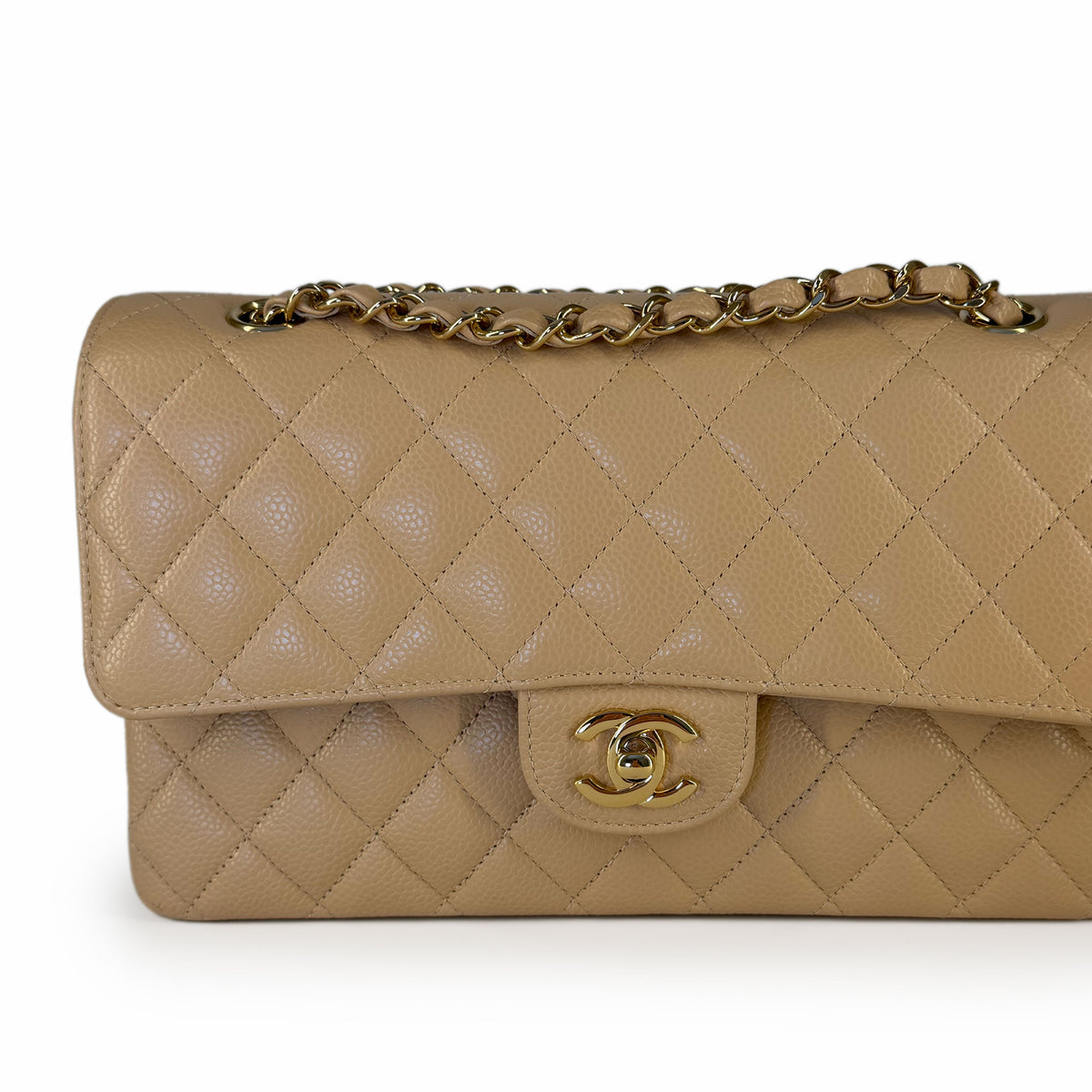 Beige quilted lambskin Chanel flap bag with gold chain and CC clasp, curated Pre-loved Luxury by Myluxe in Helsinki.