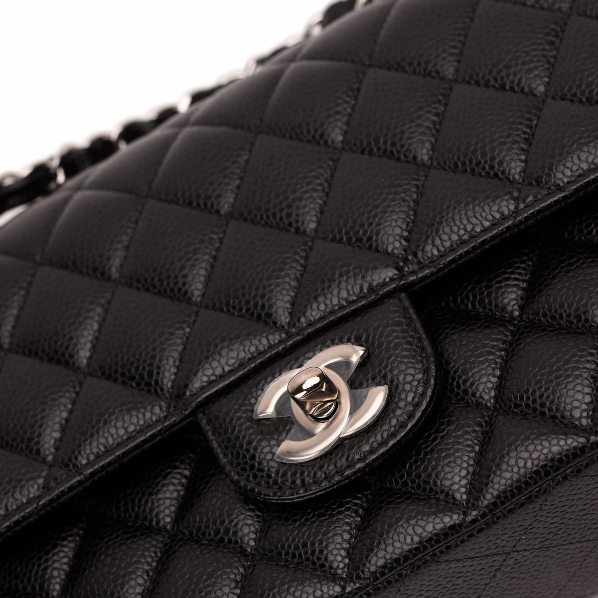 Black quilted caviar leather Chanel flap bag with silver interlocking CC logo, curated Pre-loved Luxury by Myluxe in Helsinki.
