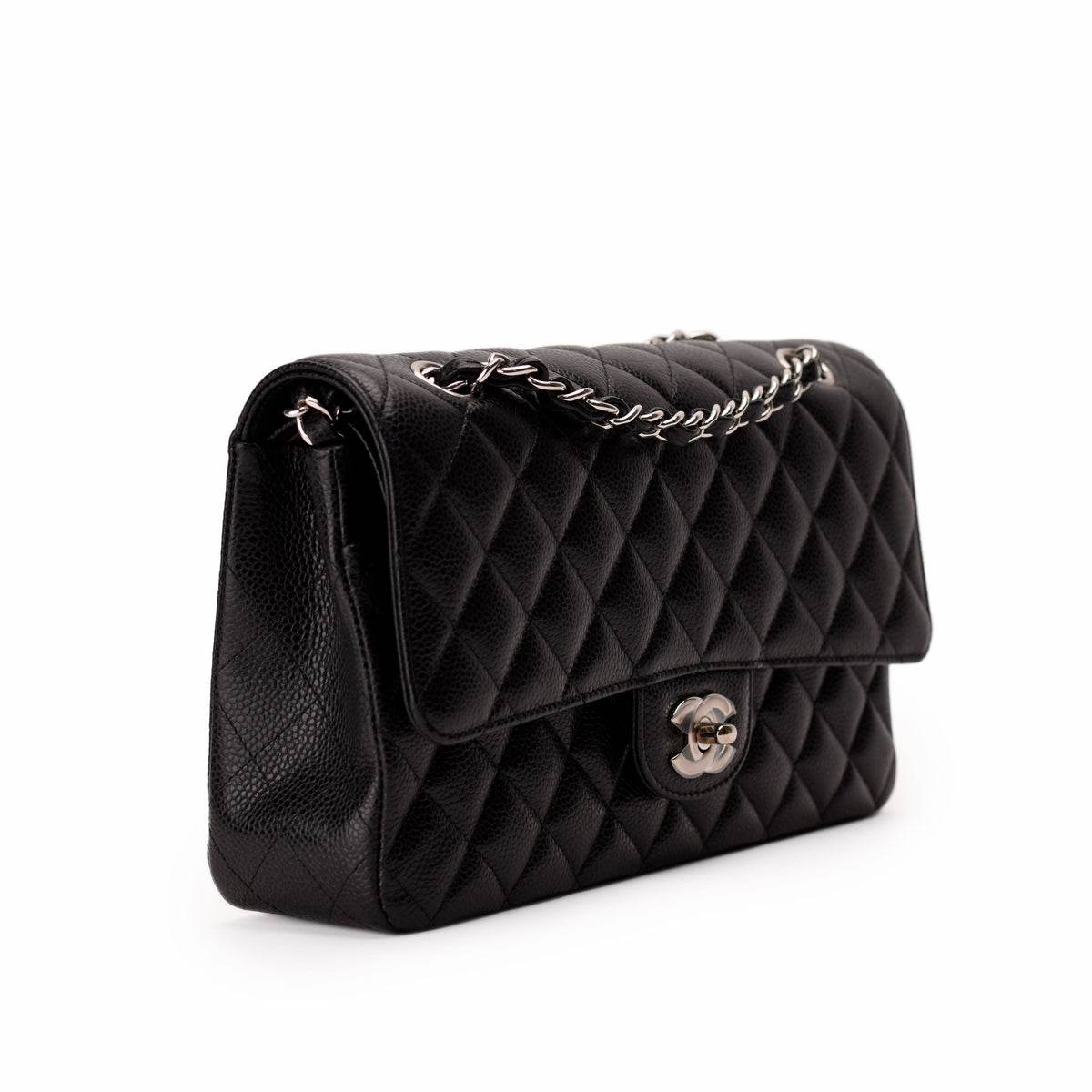 Black quilted caviar leather Chanel flap bag with silver chain strap, curated Pre-loved Luxury by Myluxe in Helsinki.