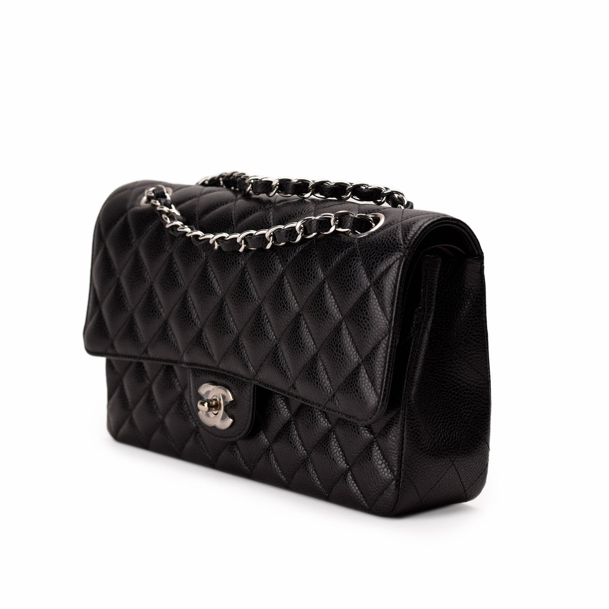 Black quilted caviar leather Chanel flap bag with silver chain strap, curated Pre-loved Luxury by Myluxe in Helsinki.