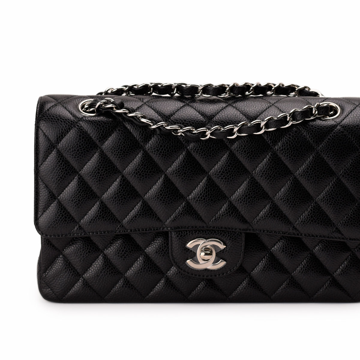 Black quilted caviar leather Chanel flap bag with silver chain strap, curated Pre-loved Luxury by Myluxe in Helsinki.