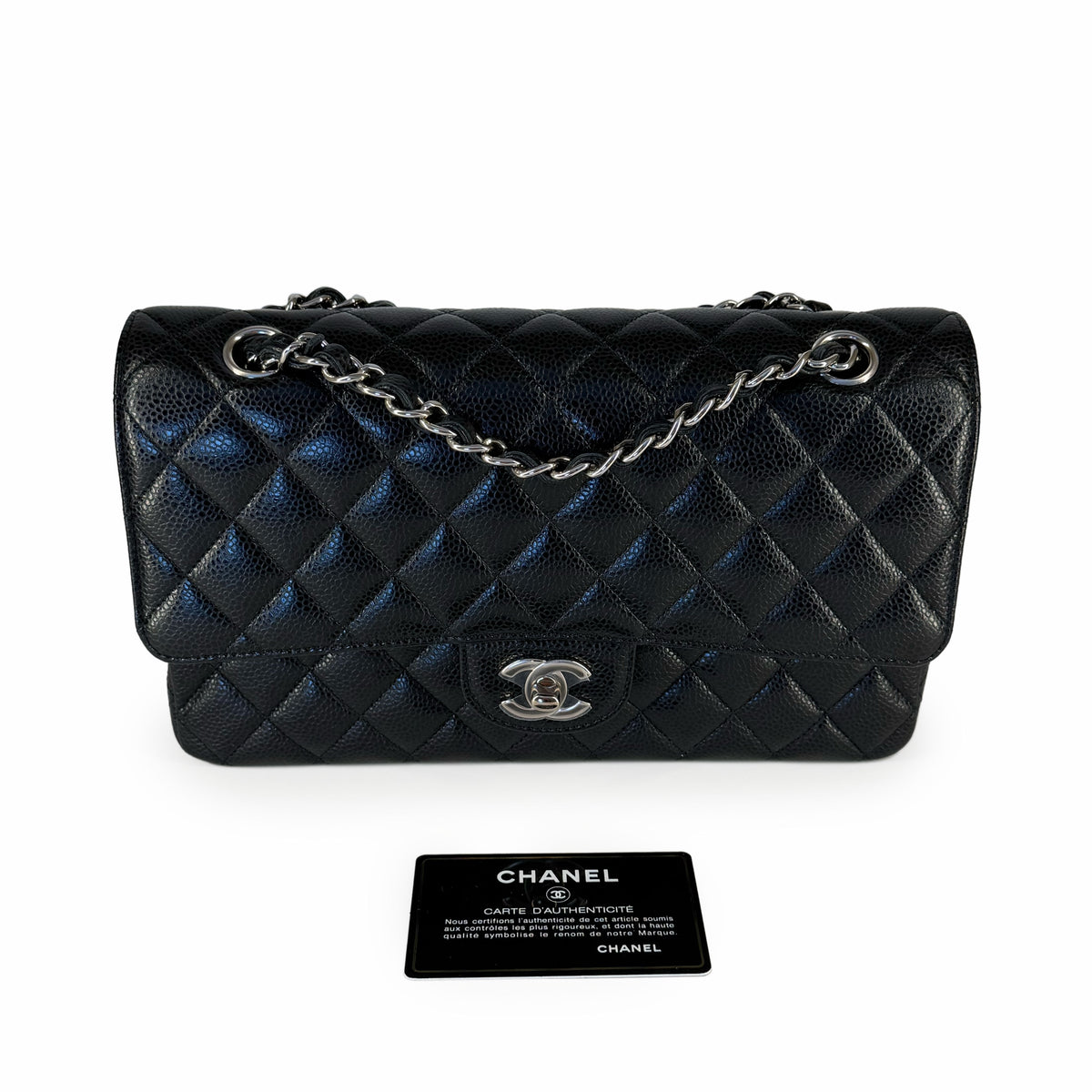 Black quilted caviar leather Chanel flap bag with silver chain strap, curated Pre-loved Luxury by Myluxe in Helsinki.