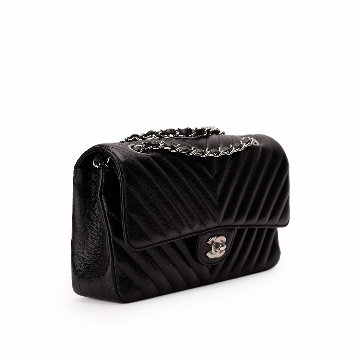 Black quilted leather Chanel flap bag with silver chain strap, curated Pre-loved Luxury by Myluxe in Helsinki.