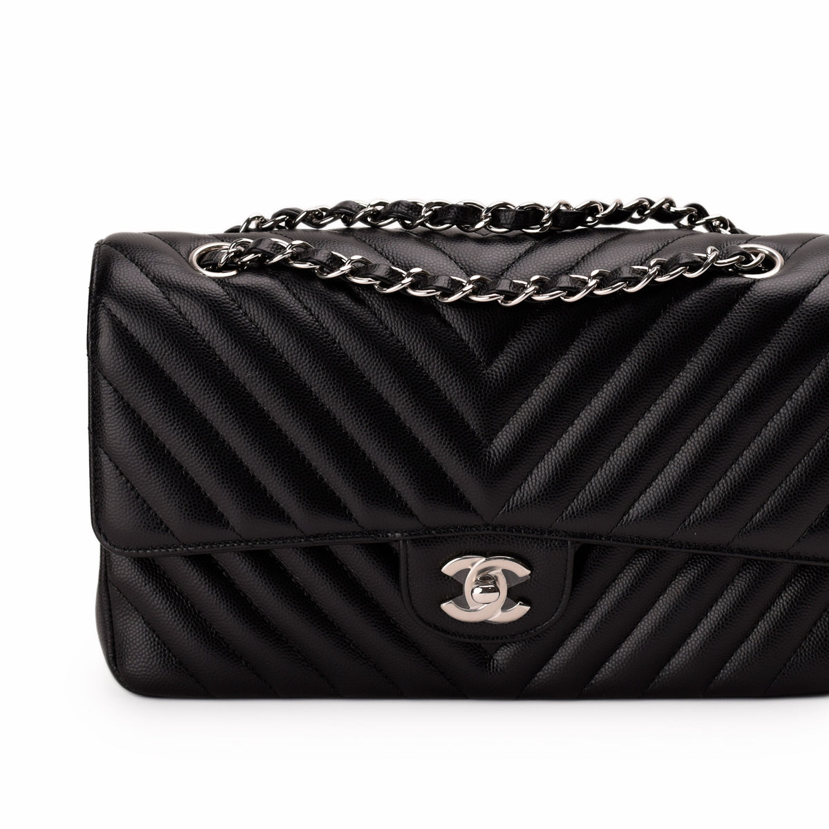 Black chevron quilted leather Chanel handbag with silver chain strap, curated Pre-loved Luxury by Myluxe in Helsinki.