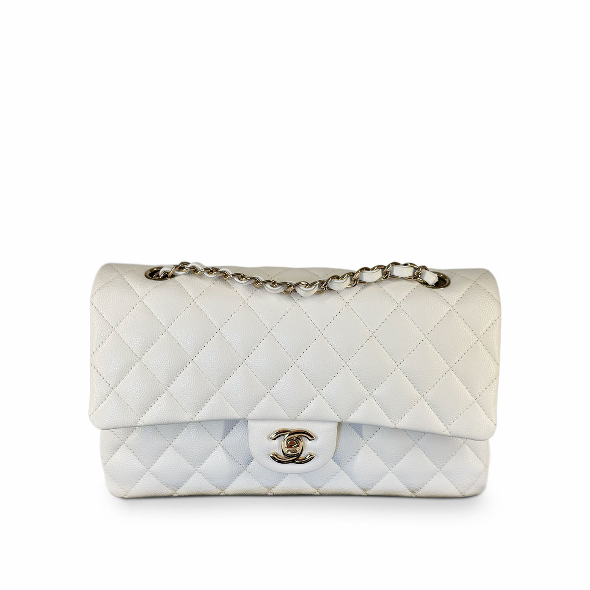 White quilted lambskin Chanel flap bag with silver chain strap, curated Pre-loved Luxury by Myluxe in Helsinki.