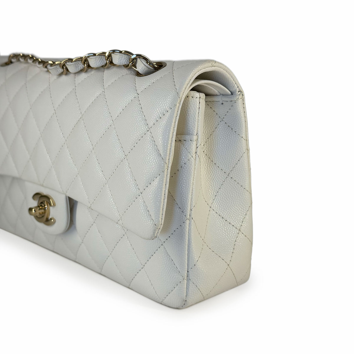 White quilted caviar leather Chanel flap bag with gold chain strap, curated Pre-loved Luxury by Myluxe in Helsinki.