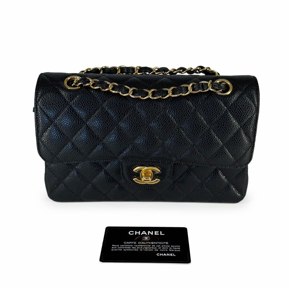 Black quilted leather Chanel handbag with gold chain strap and logo clasp, curated Pre-loved Luxury by Myluxe in Helsinki.