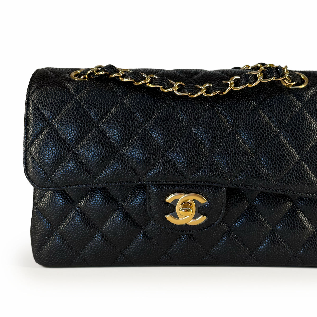 Black quilted caviar leather Chanel flap bag with gold-tone chain and logo, curated Pre-loved Luxury by Myluxe in Helsinki.