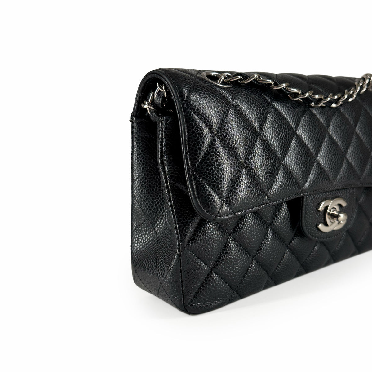 Black quilted caviar leather Chanel flap bag with silver chain strap, curated Pre-loved Luxury by Myluxe in Helsinki.