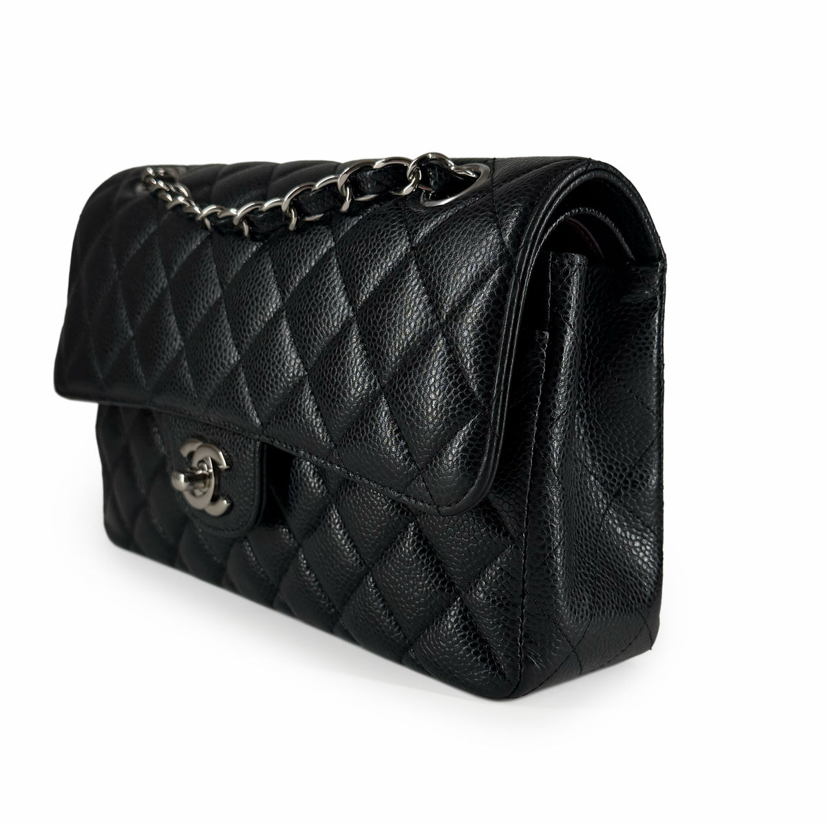Black quilted caviar leather Chanel flap bag with silver chain strap, curated Pre-loved Luxury by Myluxe in Helsinki.