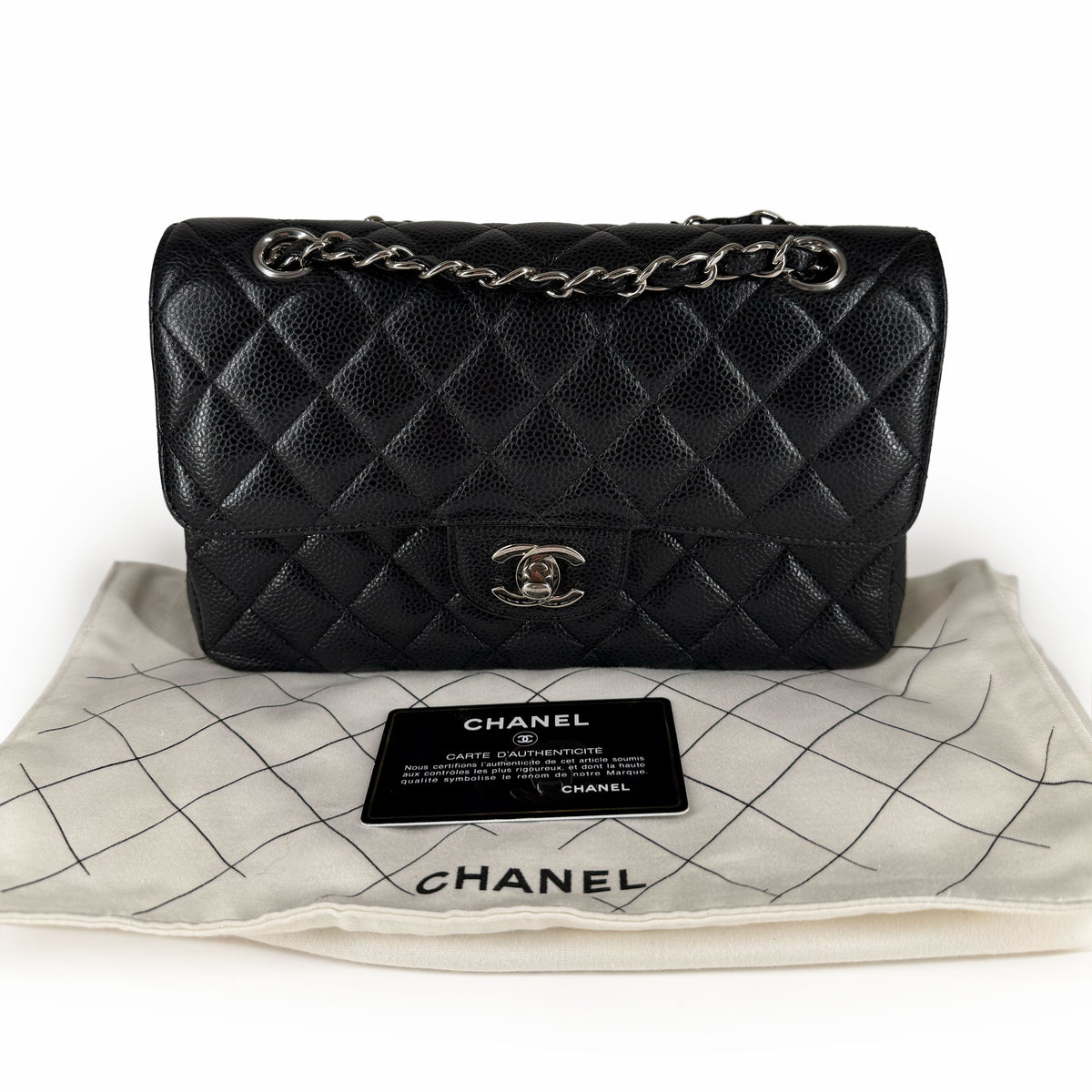 Black quilted caviar leather Chanel flap bag with silver chain strap, curated Pre-loved Luxury by Myluxe in Helsinki.