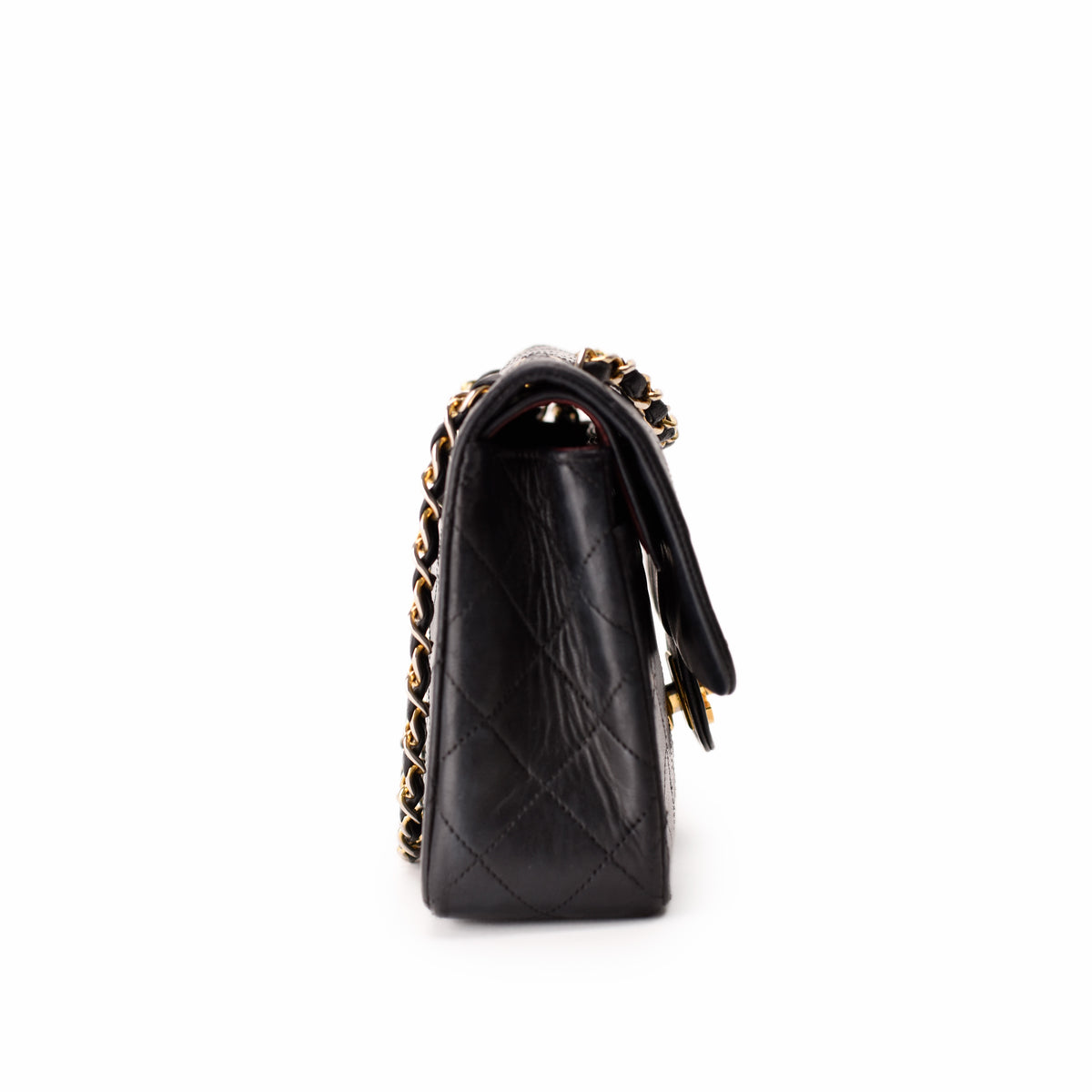 Black quilted leather Chanel handbag with gold chain strap, curated Pre-loved Luxury by Myluxe in Helsinki.