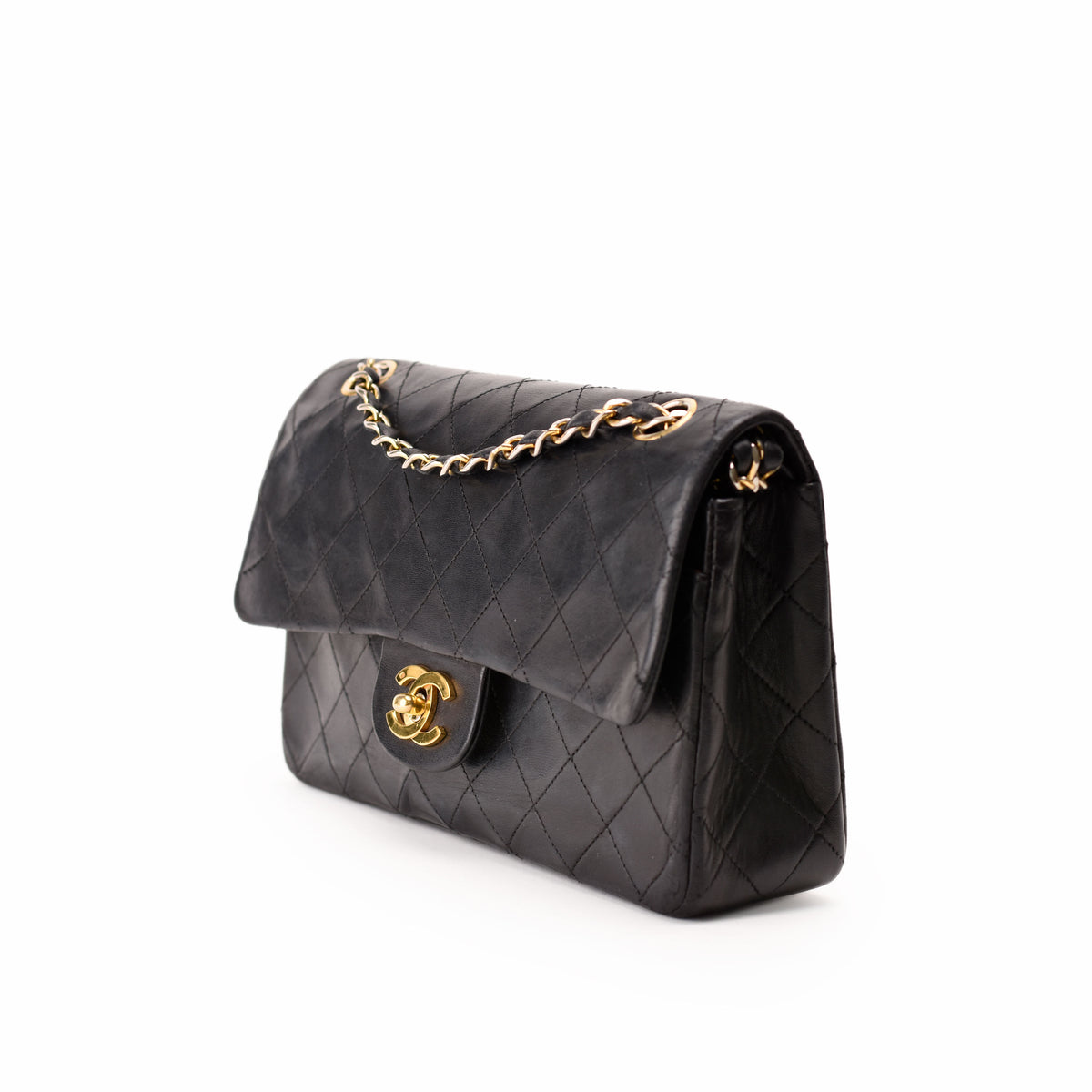 Black quilted leather Chanel handbag with gold chain strap, curated Pre-loved Luxury by Myluxe in Helsinki.