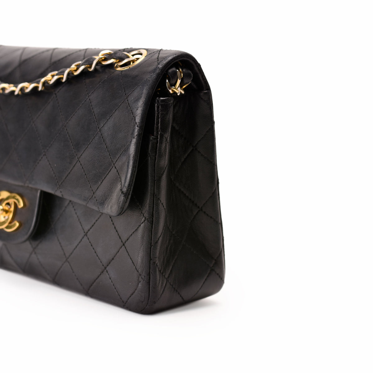 Black quilted leather Chanel handbag with gold chain strap and CC logo, curated Pre-loved Luxury by Myluxe in Helsinki.