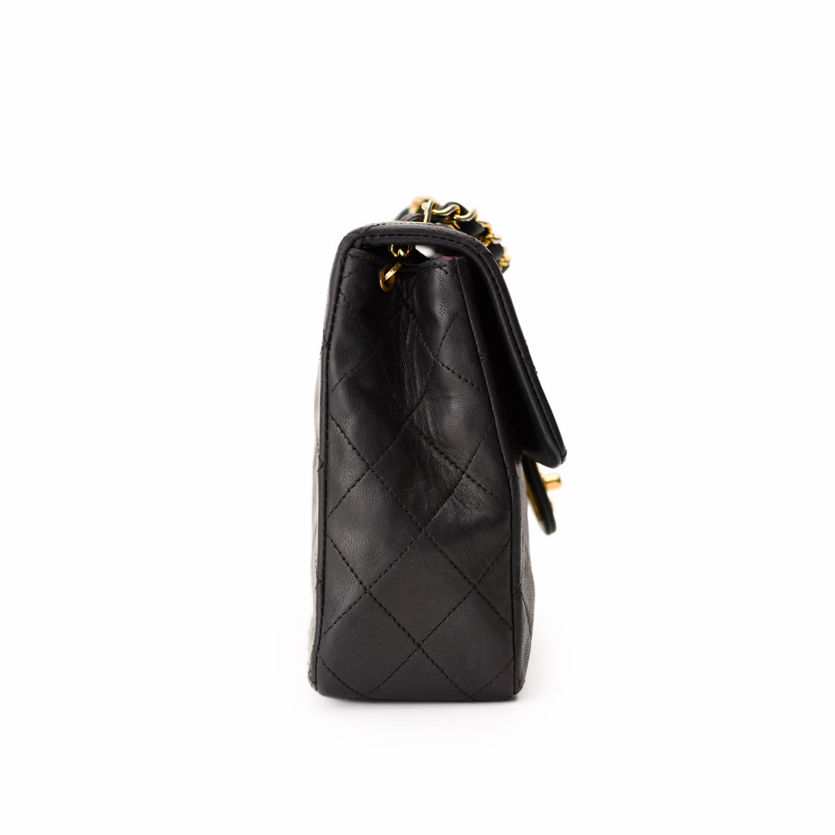 Black quilted leather Chanel handbag with gold chain strap, curated Pre-loved Luxury by Myluxe in Helsinki.