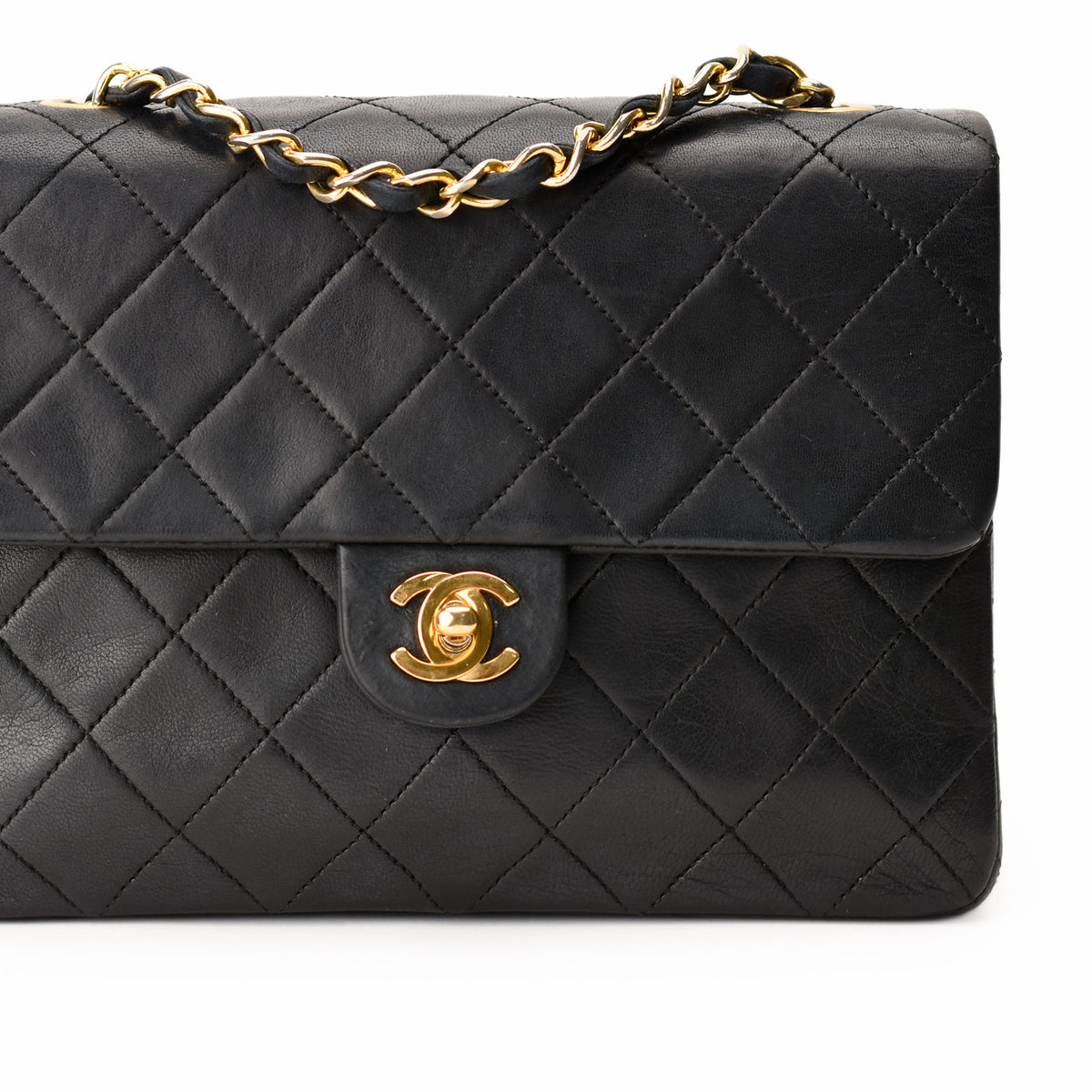Black quilted leather Chanel handbag with gold chain strap and CC lock. curated Pre-loved Luxury by Myluxe in Helsinki.