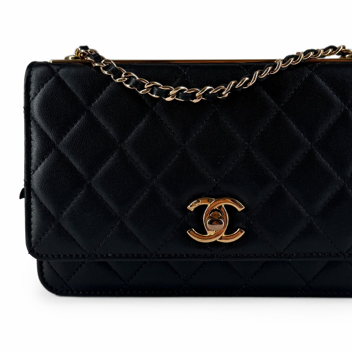Black quilted leather Chanel clutch with gold-tone chain and logo, curated Pre-loved Luxury by Myluxe in Helsinki.