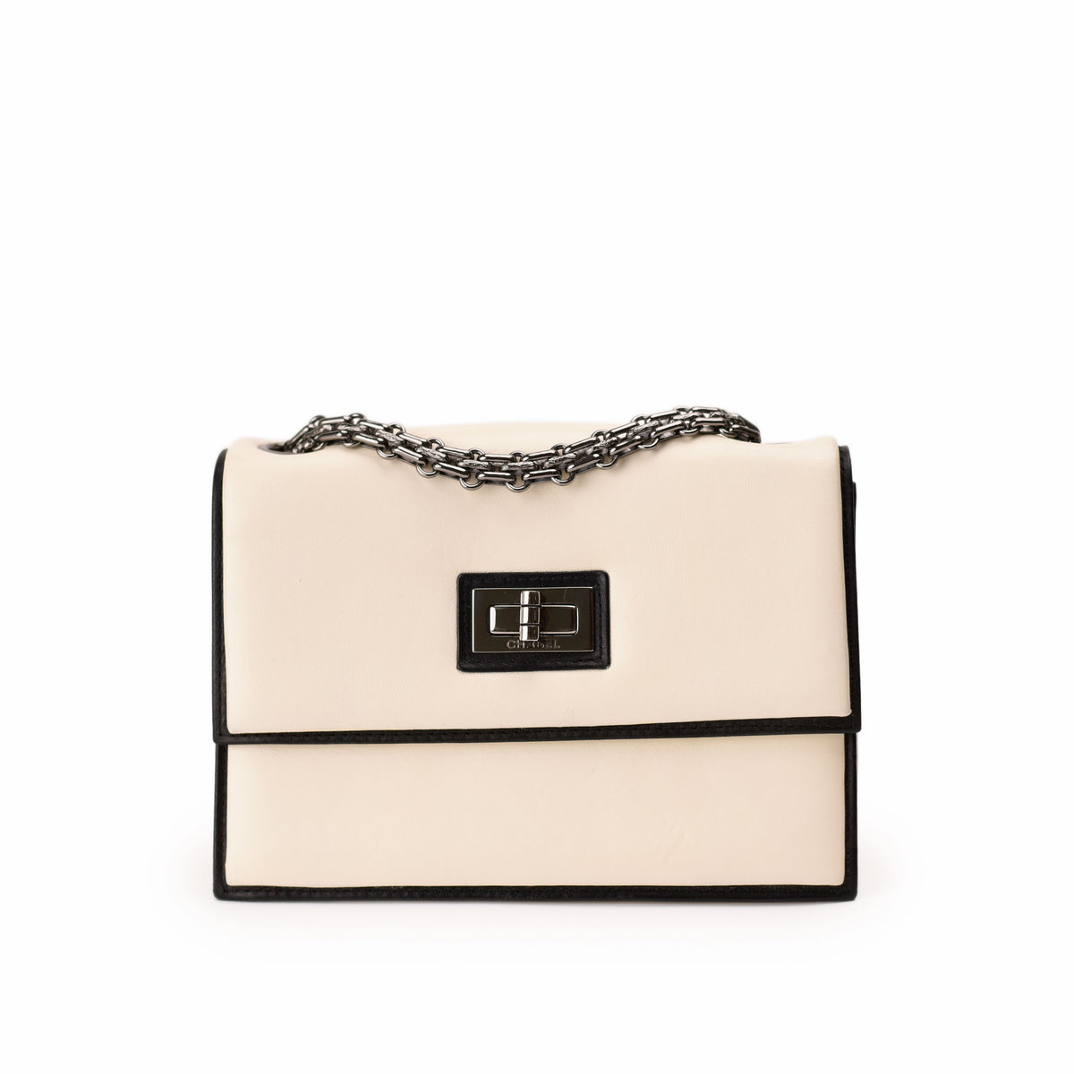 Chanel cream leather flap bag with black trim and silver chain. curated Pre-loved Luxury by Myluxe in Helsinki.