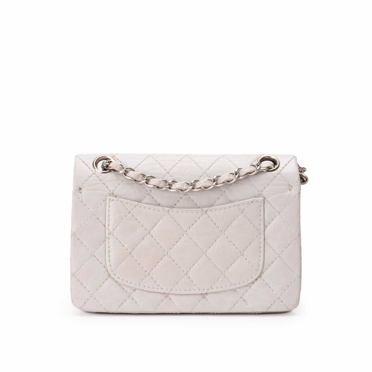 White quilted leather flap handbag with silver chain strap, curated Pre-loved Luxury by Myluxe in Helsinki.