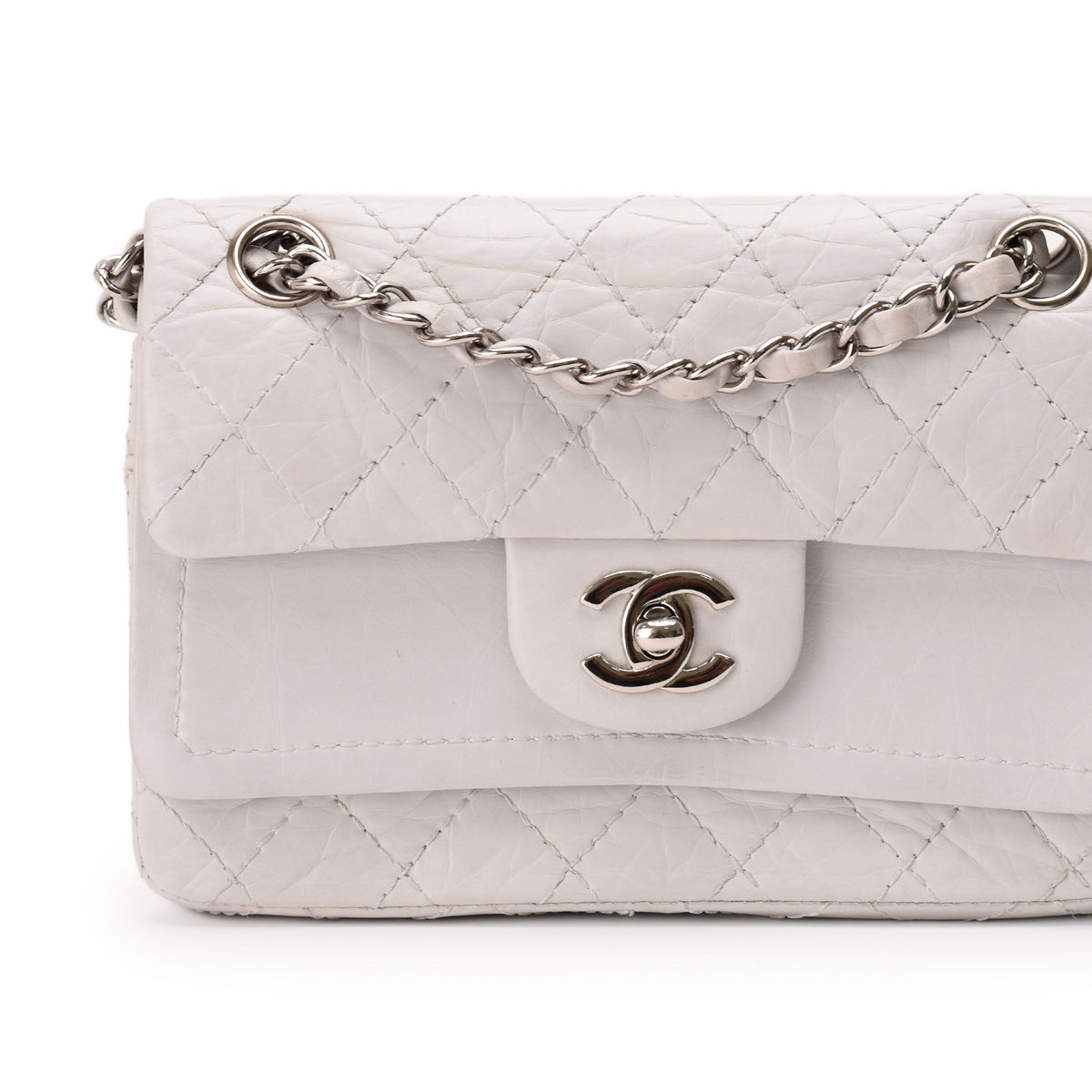 White quilted caviar leather Chanel flap bag with silver chain strap, curated Pre-loved Luxury by Myluxe in Helsinki.