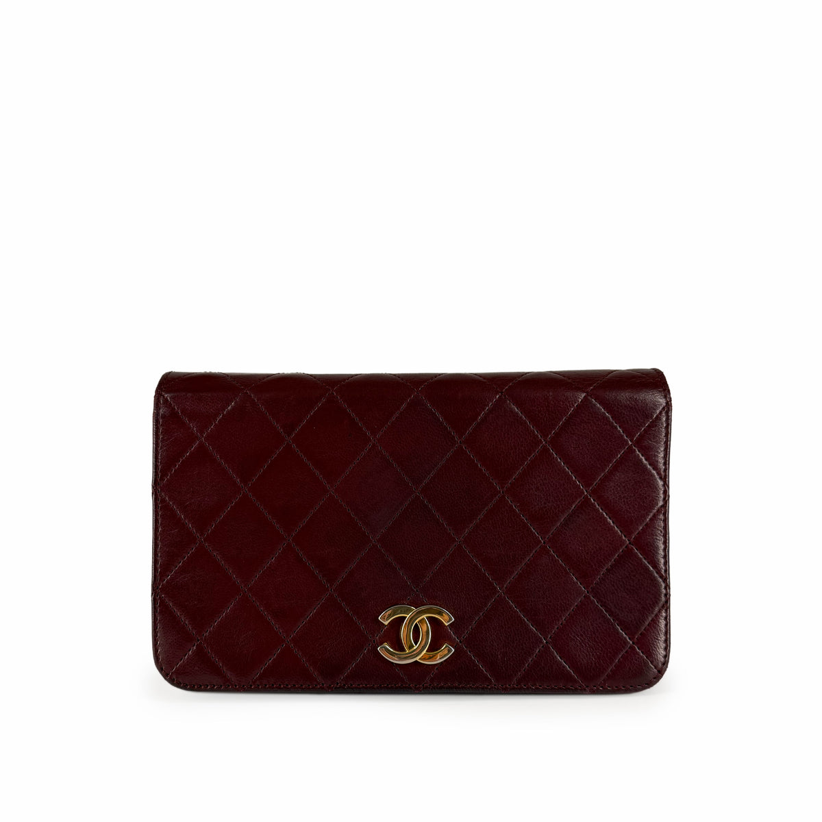 Burgundy quilted lambskin Chanel wallet with gold-tone interlocking CC logo, curated Pre-loved Luxury by Myluxe in Helsinki.