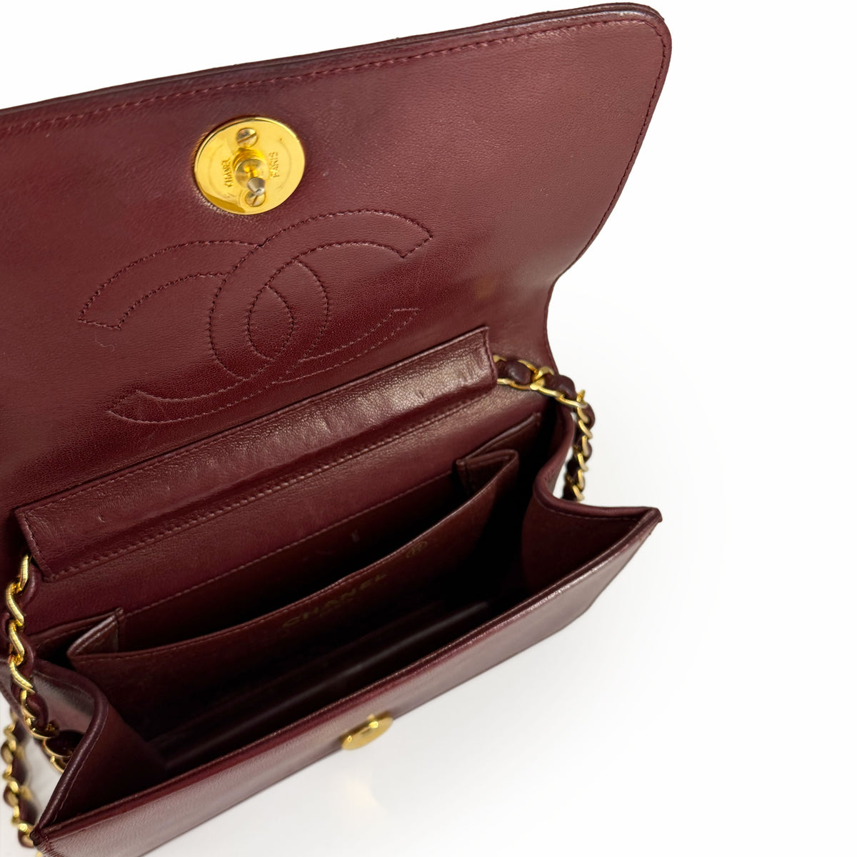 Burgundy leather Chanel flap bag with gold-tone chain and interlocking CC emboss, curated Pre-loved Luxury by Myluxe in Helsinki.