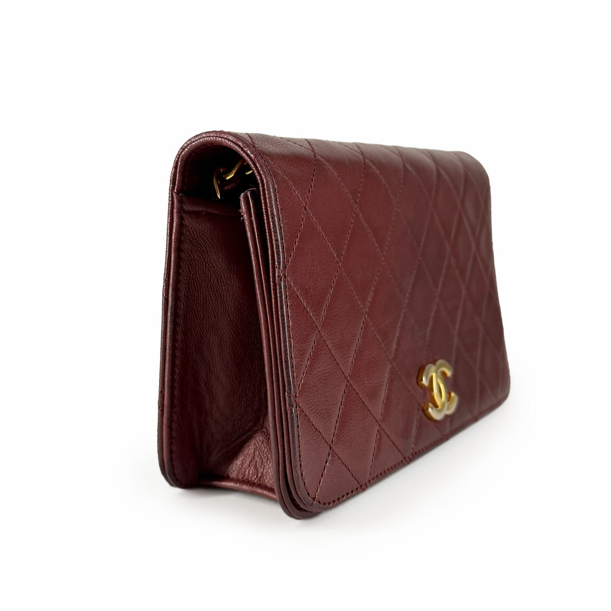 Burgundy quilted leather Chanel flap handbag with gold-tone CC hardware, curated Pre-loved Luxury by Myluxe in Helsinki.